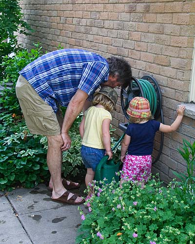 Helping Grandpa Water the Flowers