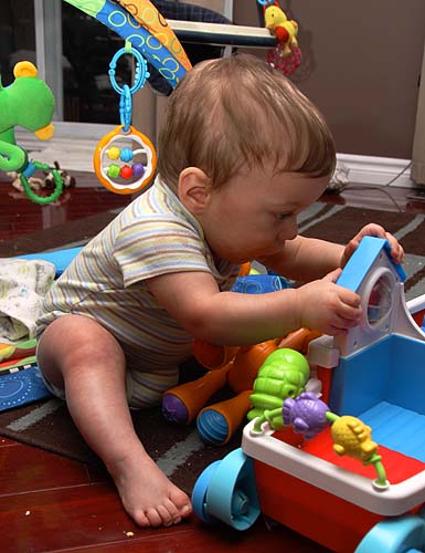 Andrew Studying His Toys