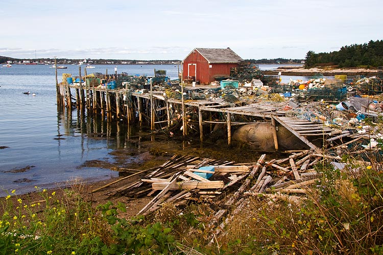Crumbling Wharf Piled with Fishing Gear