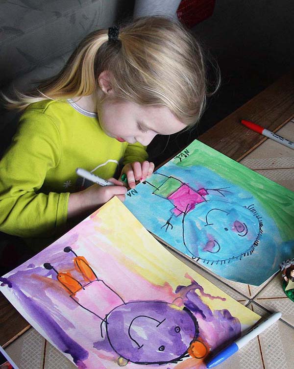 Natalya Signs the Portraits of Her Parents