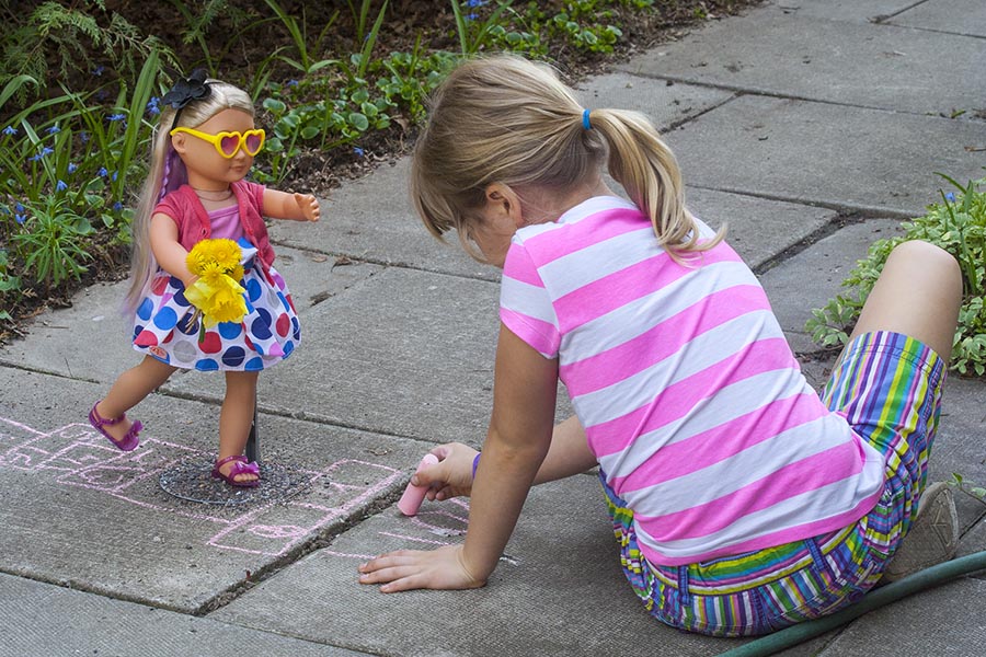 Drawing a Hopscotch for her Doll