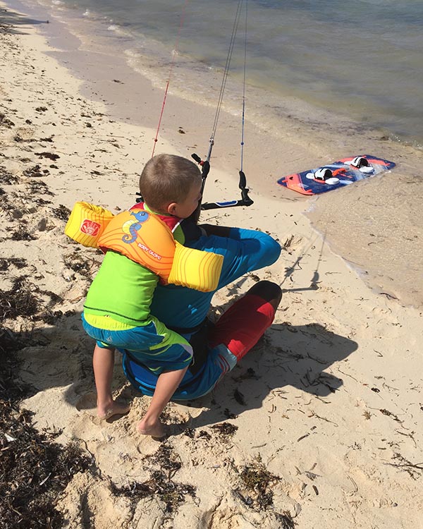 Climbing on a Kite Surfer Instructor's bBack