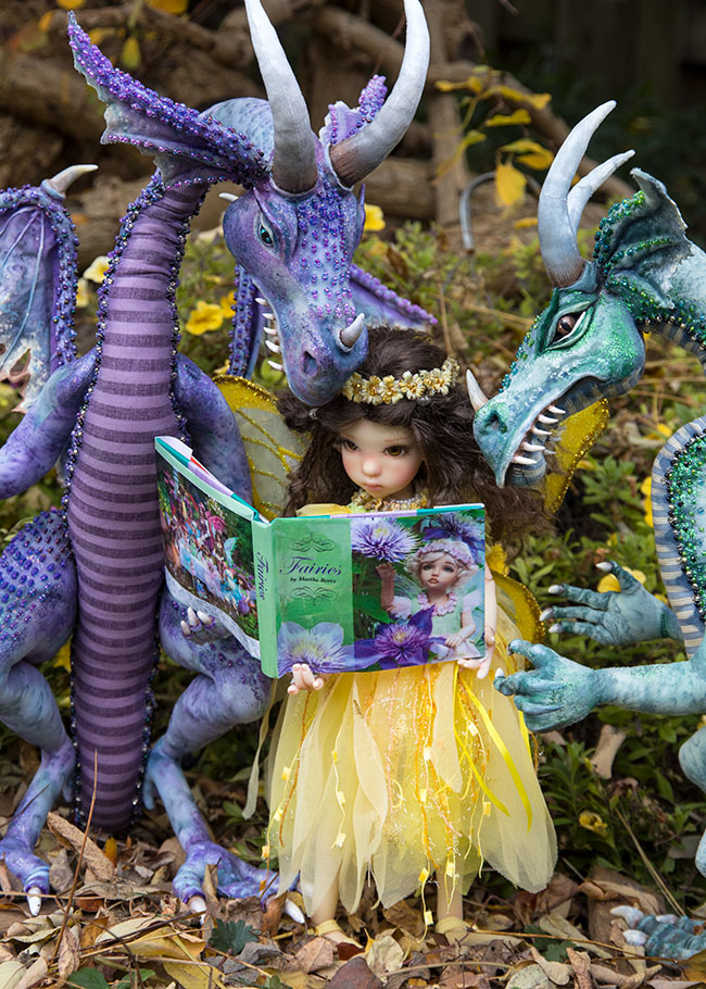 Showing the Dragons her Photos in the Fairy Book