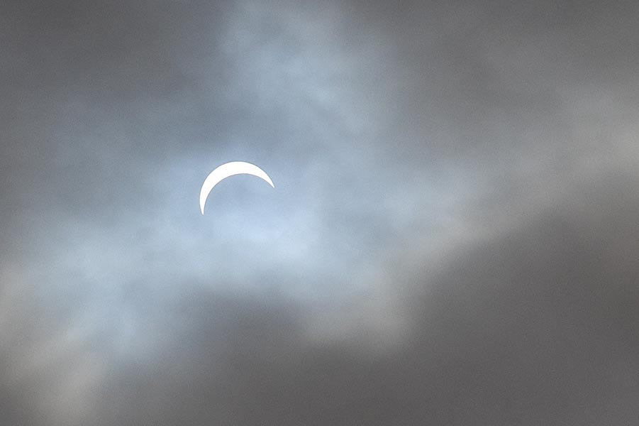 A Crescent Sun through the Clouds